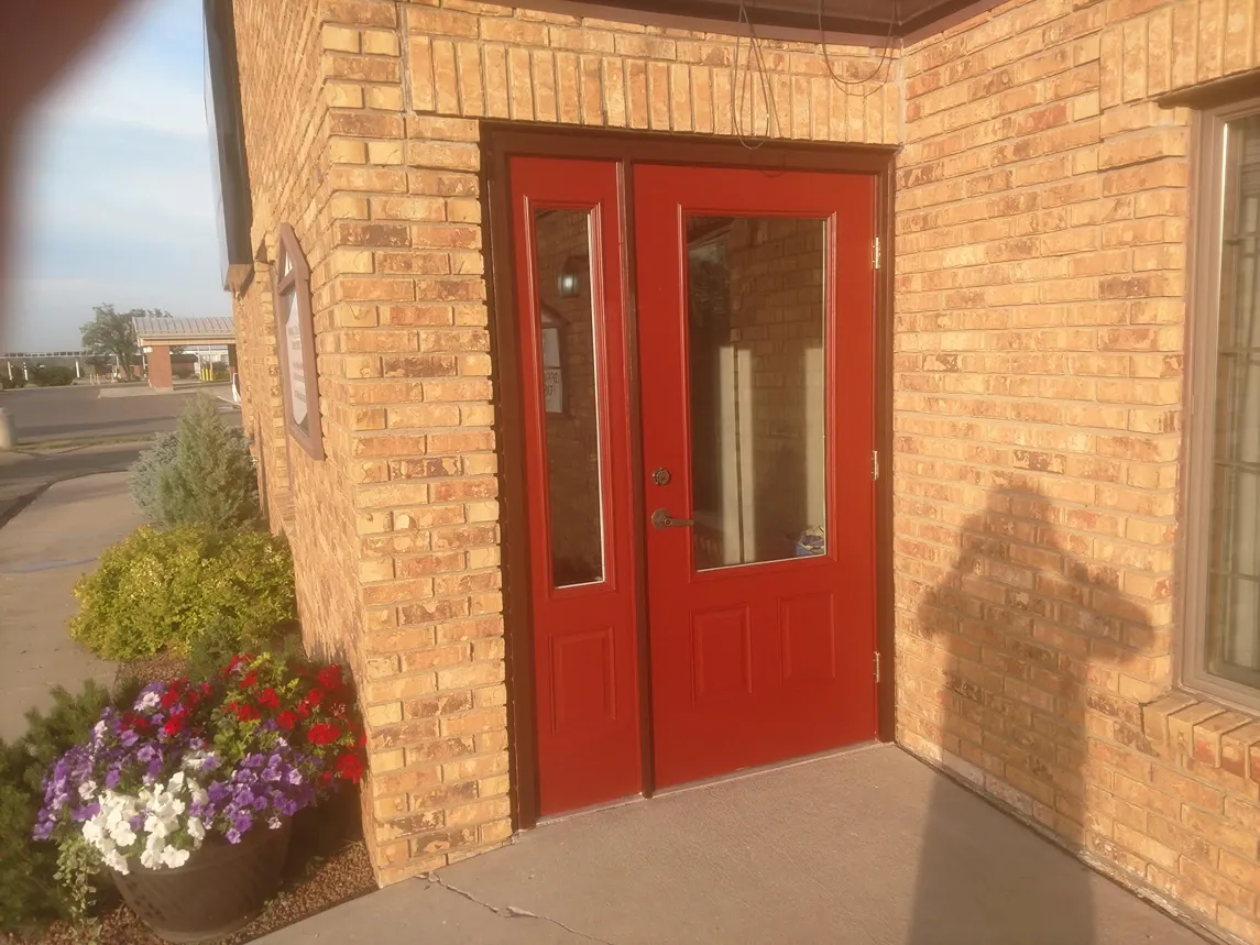 The same front door with its completed red finish